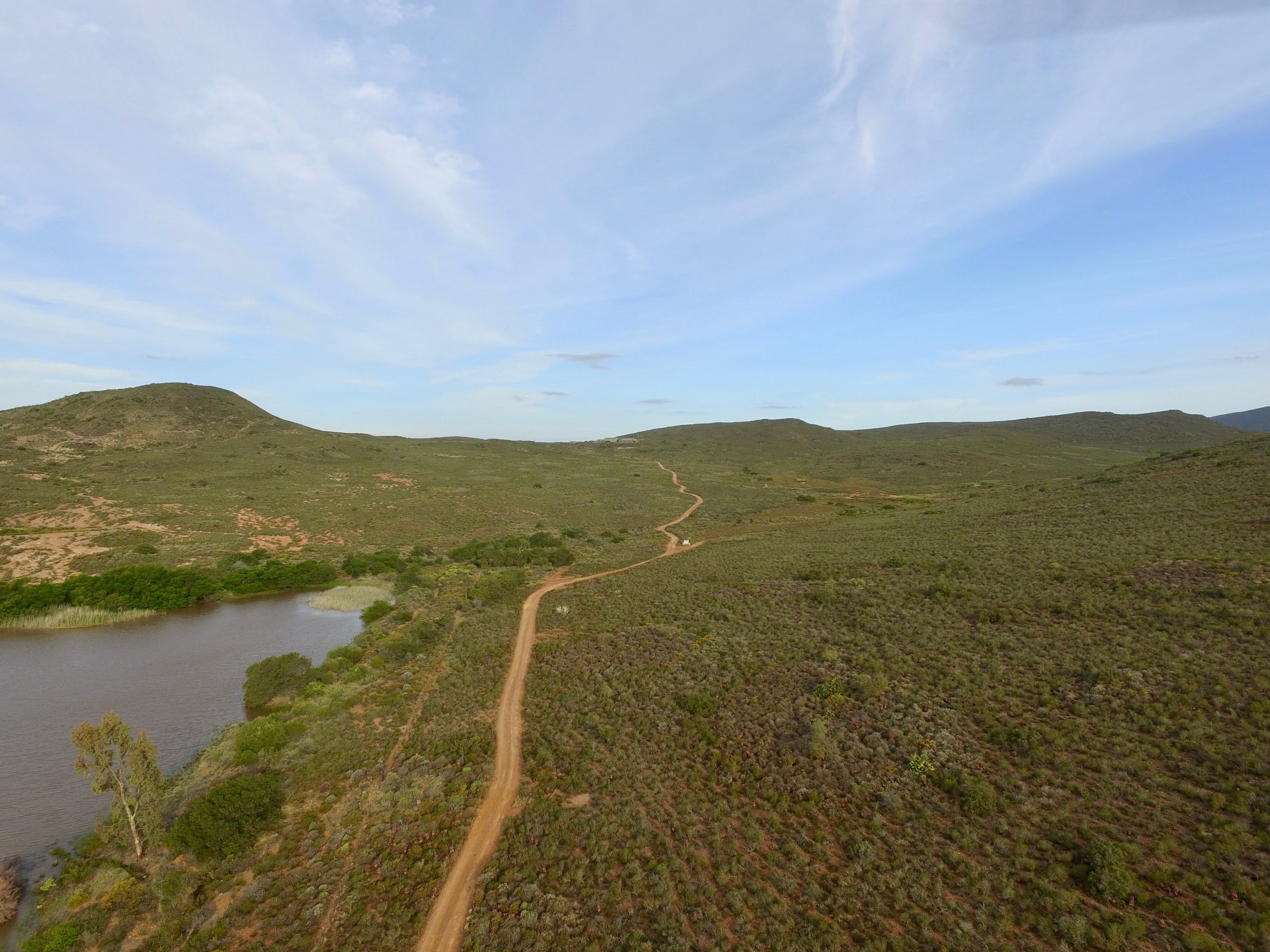 The winding arrival road through the hills at Kampala Farm